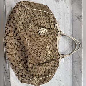 Authentic Gucci monogram large sukey tote off whit and brown with gold hardware.